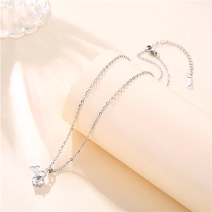 Detailed macro view of silver titanium necklace with clear cubic zirconia pendant