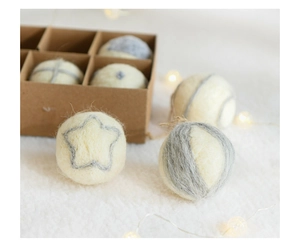 Detailed view of handmade wool felt ornaments in a gift box with warm festive lighting