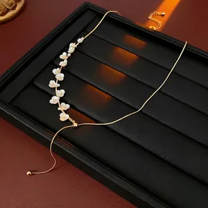 Elegant gold plated necklace with small white flowers and adjustable bead slide clasp