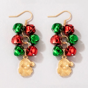 Detailed shot of Christmas earrings with red and green bells and golden glove charms