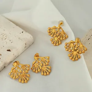 Elegant pine branch stud earrings in gold titanium steel on stone and silk fabric