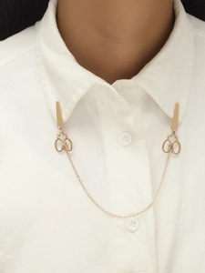 Detailed view of creative golden scissors collar pins set with link chain on white shirt