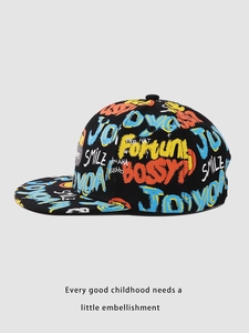 Detail view of colorful graffiti prints and SMILE lettering on kid's black hip hop cap