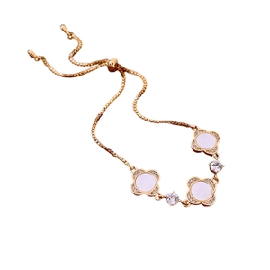 Adjustable gold plated flower bracelet with white shell and sparkling zircon accents