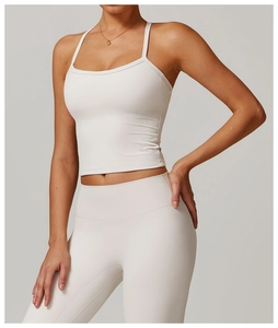 Close-up of brushed off-white yoga vest and high-waisted leggings on a model