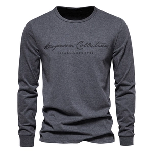 Detail of dark grey cotton long sleeve T-shirt with ribbed cuffs and textured chest embroidery
