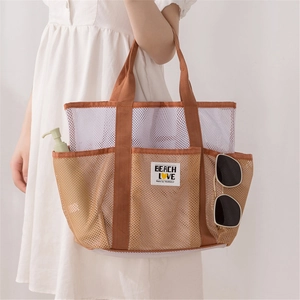 Mesh beach tote bag with pockets and BEACH LOVE label shown with model