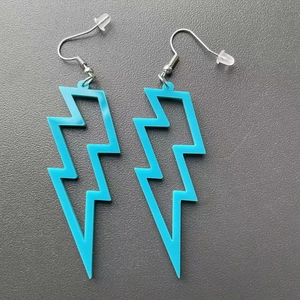 Blue acrylic lightning bolt earrings with silver hooks for a trendy geometric style