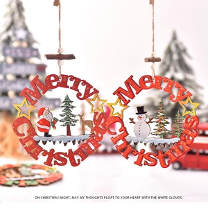 Detail of wooden Merry Christmas ornaments featuring Santa and Snowman designs