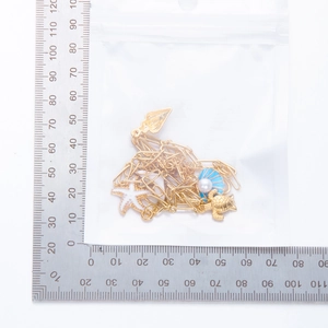 Detailed size measurement of a gold necklace with starfish, turtle and shell pendants