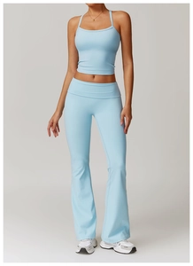 Detail view of light blue flared yoga pants and cropped fitness tank top set