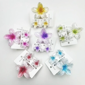 Plumeria hair claw clips set in various gradient colors for beach vacation styles
