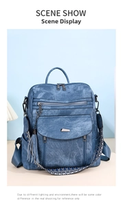 Detail of blue denim PU backpack with colorful patterned strap and tassel pendant