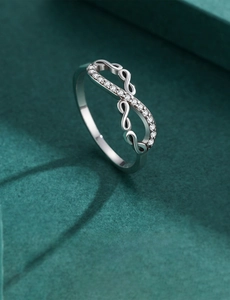 Macro shot of 925 silver infinity wave ring with micro-pave white zircon stones