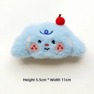Detail showing dimensions of blue plush puppy hair accessory with cherry and music notes