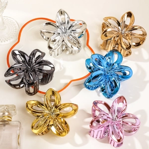 Detail view of colorful metallic frangipani hair claw clips in assorted vibrant shades