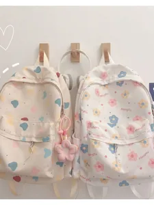 Kawaii Korean style canvas backpacks with cartoon prints and plush flower charms
