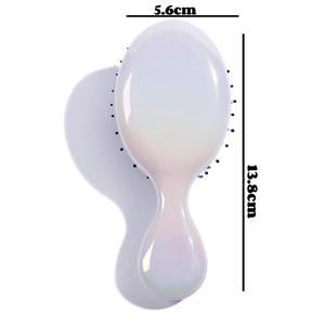 Detailed view of iridescent pearl mini hairbrush with dimensions 5.6cm by 13.8cm