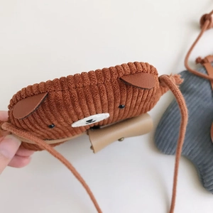 Close-up of brown corduroy kid's bear bag showing ribbed fabric texture and embroidery
