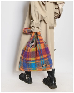Detail of colorful plush plaid tote bag with textured fleece and 79 FASHION logo tag