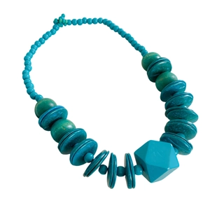Ethnic style necklace with teal wood beads, coconut shell disks and a faceted pendant