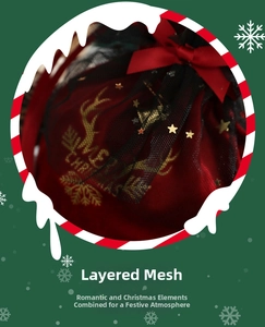 Detail of red velvet Christmas gift bag with black mesh overlay and gold reindeer print