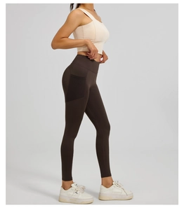 Detail view of high waist yoga leggings with functional side mesh pocket for storage