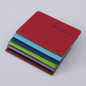 Stack of multi-colored premium PU leather passport covers with embossed lettering on top
