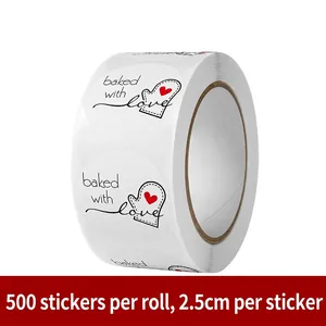 Macro view of 500-count Baked with Love round stickers, 2.5cm diameter on a white roll