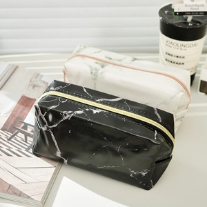Detail view of stylish marble pattern PU leather stationery bags with gold zippers