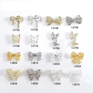 Collection of 16 gold and silver 3D metal bow tie nail charms with sparkling rhinestones