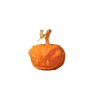 Handcrafted orange pumpkin aromatherapy candle with spooky face for Halloween decor