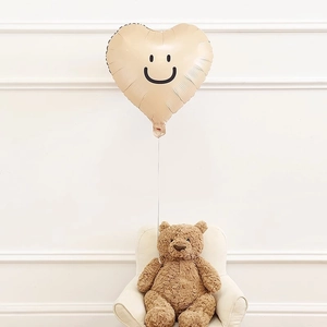 Beige heart shaped smiley face foil balloon for minimalist kids birthday party decor