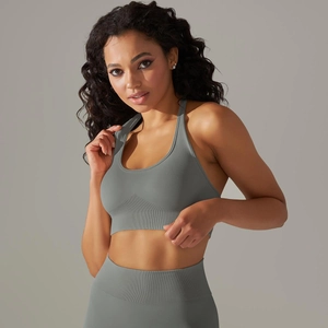 Close-up of seamless dark grey ribbed texture on a high-support sports bra and yoga leggings