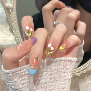 Close-up detail of handmade macaron gradient cat-eye press-on nails with hand-painted tulip art