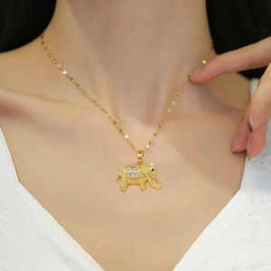 Elegant gold elephant necklace with sparkling rhinestones worn on a minimalist necklace