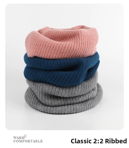 Detail of pink, navy, and grey 2:2 rib knit neck warmers stacked with soft texture