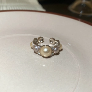Macro shot of French vintage pearl ring with zircon accents on a ceramic plate