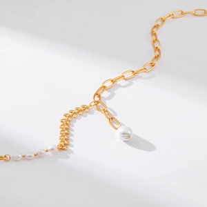 Close-up of 18K gold plated wheat leaf design with elegant white pearls on the necklace