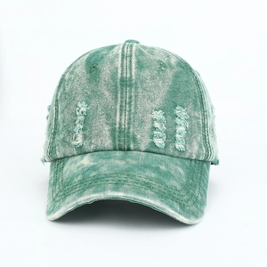 Detailed macro view of distressed washed denim baseball cap with frayed edges and texture