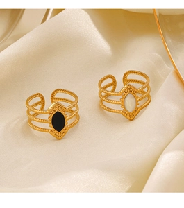 Detail of vintage gold-plated diamond-shaped rings with black and white stone inlays