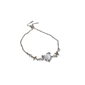 Bracciale cuore occhio di gatto con ciondoli a stella e chiusura bolo regolabile