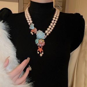 Macro shot of double-layer pearl necklace with seashell and starfish rhinestone charms