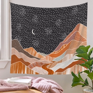 Hanging starry sky and moon tapestry above a cozy sofa area with decorative props