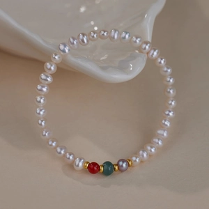 Detail of freshwater pearl bracelet with colorful agate beads and gold spacers