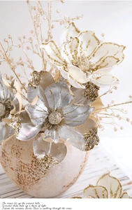 Close-up of elegant Christmas flowers with glitter petals in a vintage ceramic vase
