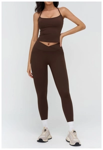 Deep brown yoga set detail showing V-shaped crossover waistband and side hidden pockets