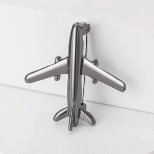 Detailed back view of a minimalist airplane brooch in gunmetal finish with pin clasp