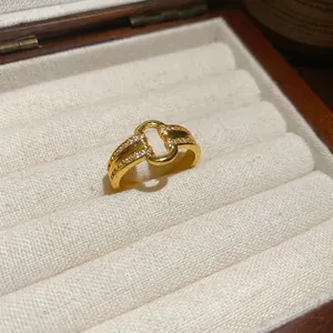 18k gold plated maple leaf bow open ring with sparkling cubic zirconia on a jewelry box