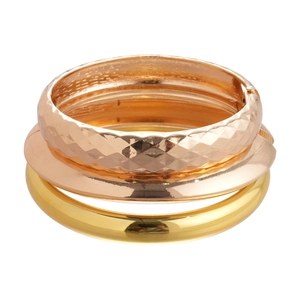 Three-piece stackable geometric metal bangles in polished gold and rose gold finish